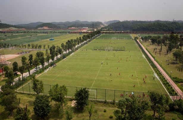 A view of Guangzhou Evergrande’s youth academy, the world’s largest, which contains 50 pitches and over 2,500 students. 24 Spanish, Real Madrid coaches are employed at the school. Source: Mirror/ Getty Images 