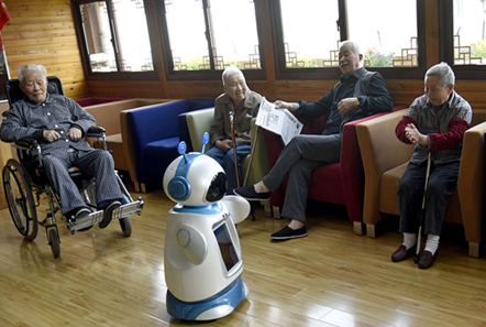 Elderly people interact with AI robot in Hangzhou. third-child policy