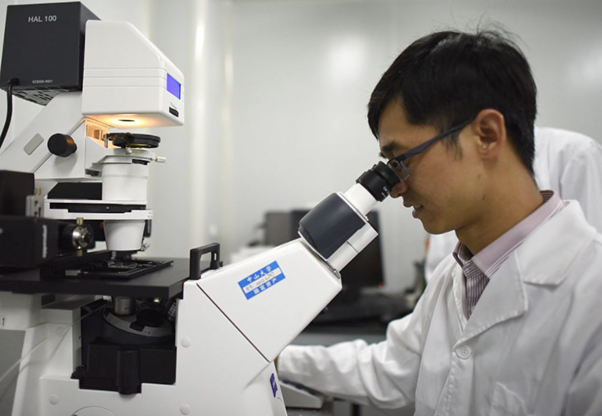 A Chinese scientist in Guangzhou examining CRISPR gene editing China’s biopharmaceutical market